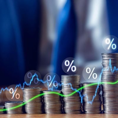 Businessman putting down money, pointing with pen and showing candlestick symbol for investing, finance, saving money, interest rate or dividend investment, business growth concept.